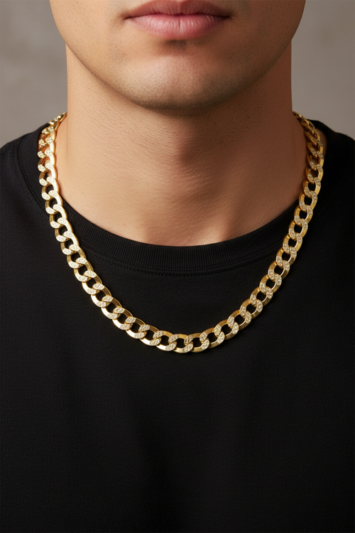 A close-up of a man wearing a thick gold Cuban link chain necklace over a black t-shirt.