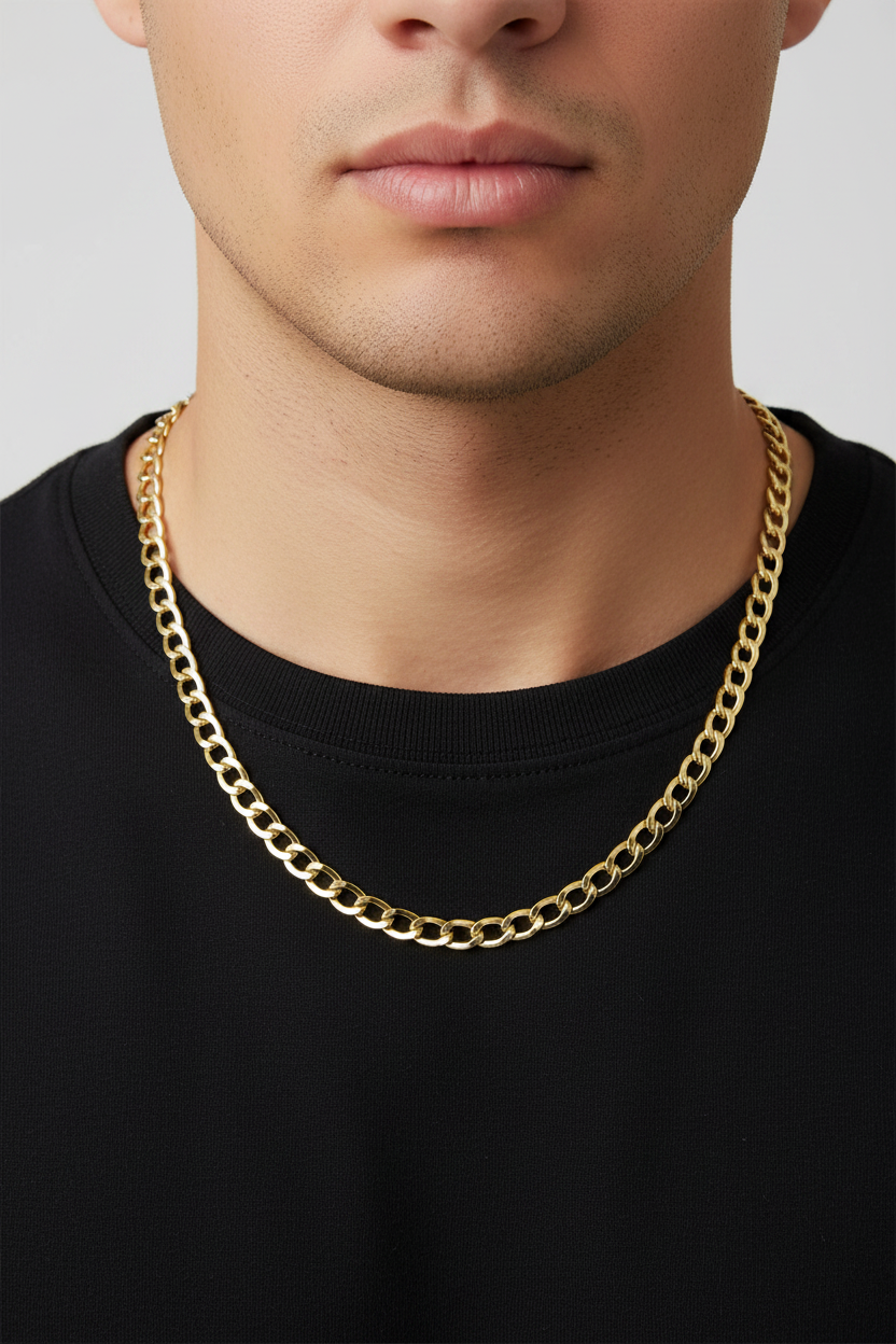 A close-up of a man wearing a thick, shiny gold chain necklace over a black crewneck shirt, against a light gray background.