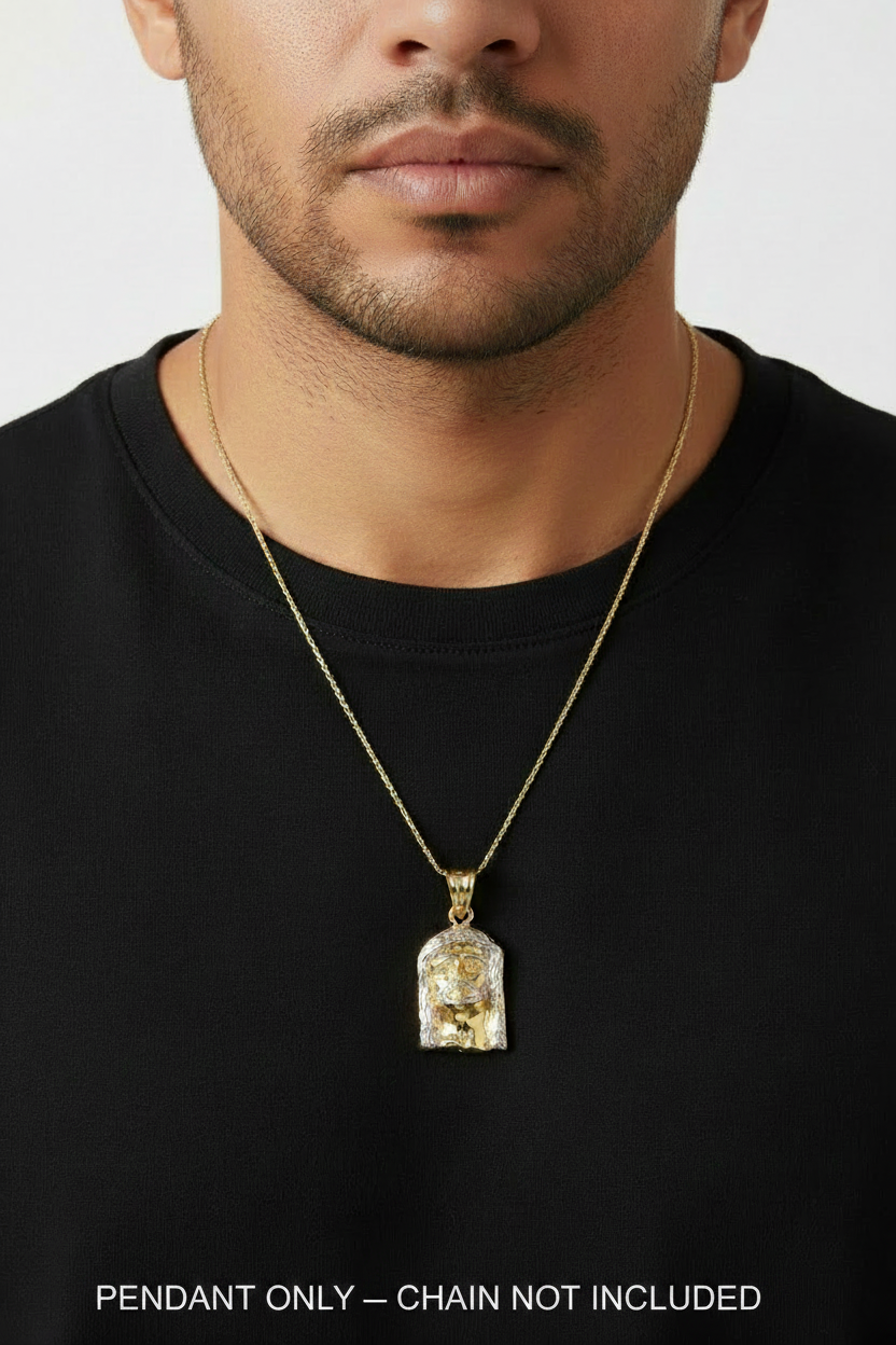 A close-up of a man wearing a gold chain necklace with a clear acrylic pendant containing gold foil details, set against a plain light gray background.