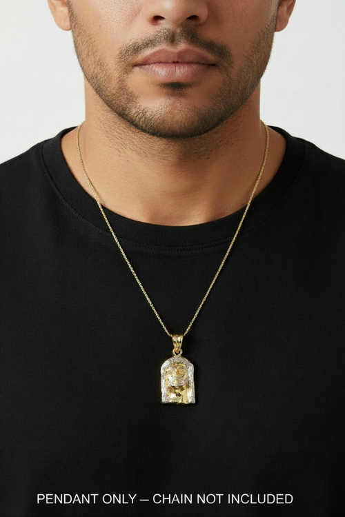A close-up of a man wearing a gold chain necklace with a clear acrylic pendant containing gold foil details, set against a plain light gray background.