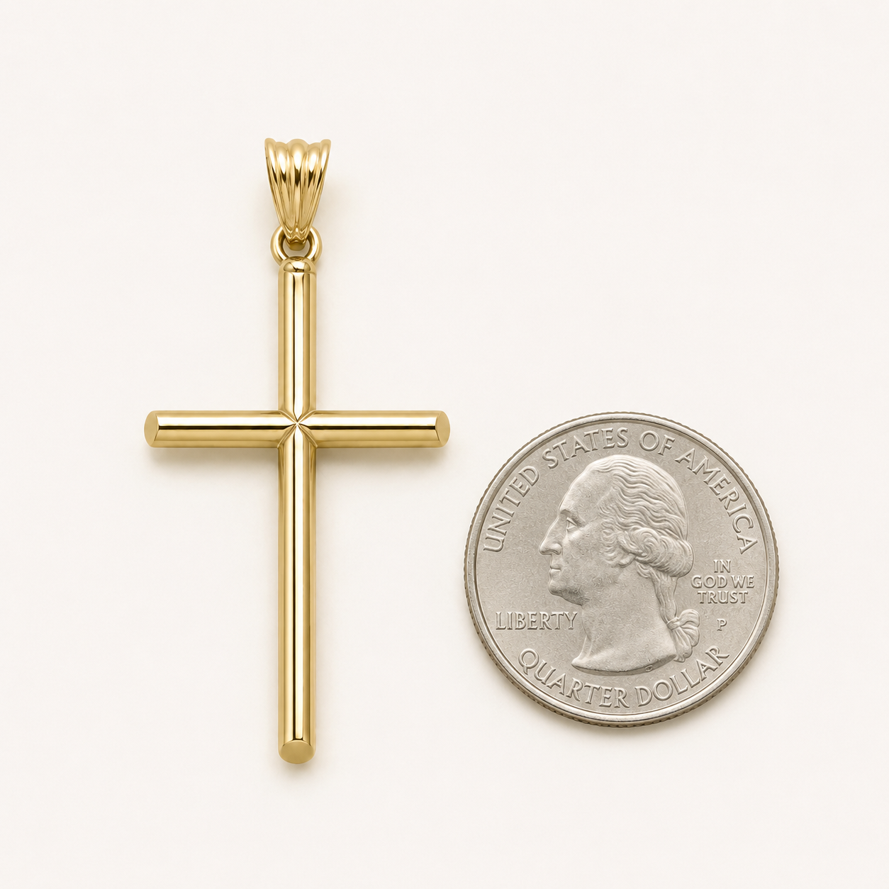 A polished yellow gold cross pendant displayed next to a US quarter coin for scale, on a clean off-white background.